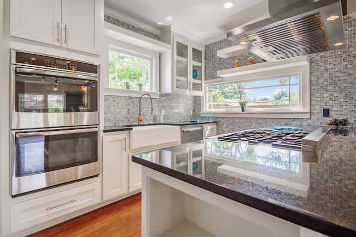 An image of a modern kitchen with sleek appliances, featuring a gas stove, refrigerator, and built-in microwave in Irvine